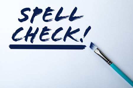 Spell Check. Text and paint brush on white backgroundの写真素材