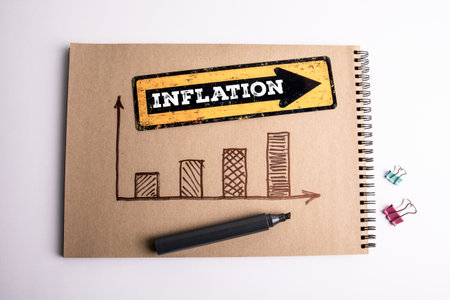 Inflation Concept with Hand-Drawn Bar Chart and Marker on Kraft Paper Notebook.の写真素材
