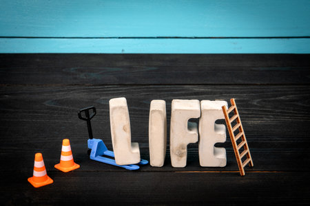 LIFE Concept. Concrete alphabet letters on a blue and black wooden backgroundの写真素材