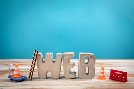 WEB Concept. Concrete Alphabet Letters on a White Wooden and Blue Backgroundの写真素材