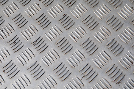 Textured Steel Tread Plate Surface with Diagonal Anti-Slip Pattern for Industrial Useの写真素材