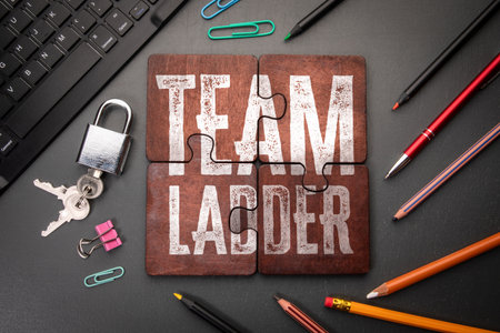 Team Ladder. Wooden puzzle pieces with text on a dark office tableの写真素材