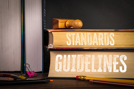 Standards and Guidelines. Books with Stamp and Office Supplies on Deskの写真素材
