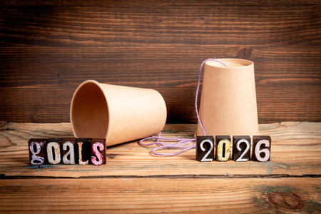 2026 Goals Concept. Paper Cup Phone on Wooden Table