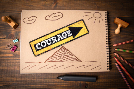 Courage and Growth Concept Sketch on Brown Notebook with Arrow and Pyramid Drawingの写真素材
