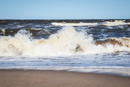 Powerful Sea Wave Crashing onto Shoreline During Windy Day on the Coastの写真素材
