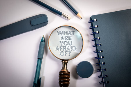 Magnifying Glass with Motivational Question What Are You Afraid Of Among Office Suppliesの写真素材