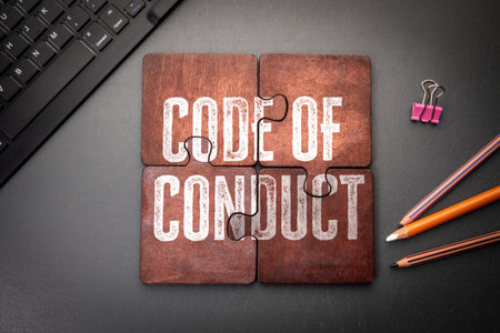 Code of Conduct Concept Shown on Puzzle Pieces in Office Workspace Settingの写真素材