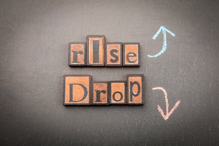 Rise and drop concept with wooden blocks and arrows