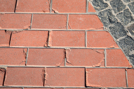 Cracked Red Pavement Tiles and Cobblestone Intersection Surface
