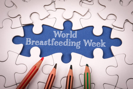 1 to 7 August is World Breastfeeding Week. White puzzle pieces and colored pencilsの写真素材