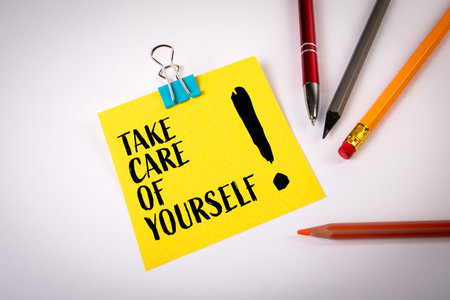Take care of yourself concept with yellow note paper and stationery on desk. Symbol of health