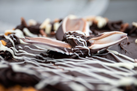 Close-up of chocolate cake with cream decoration and artistic topping