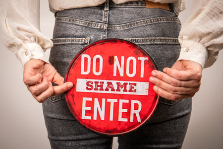 Do Not Enter Shame Concept Sign Held By Person In Jeans