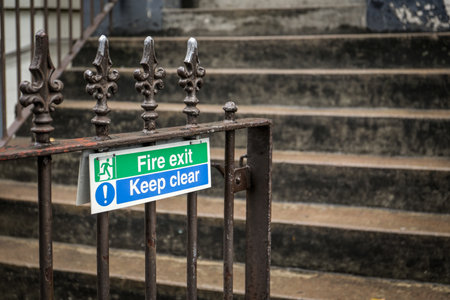 Fire Exit Keep Clear Safety Sign on Metal Fence