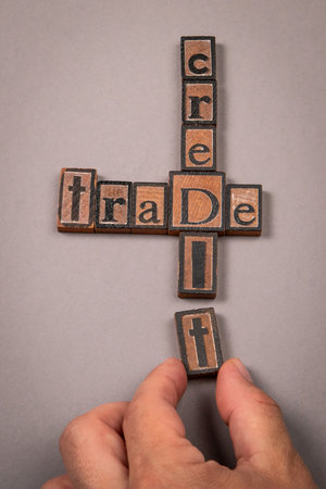 Concept of Trade and Credit with Wooden Letter Blocks on Gray Backgroundの写真素材