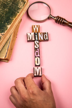 Concept of Wisdom and Mind with Wooden Letter Blocks and Vintage Books on Pink Backgroundの写真素材