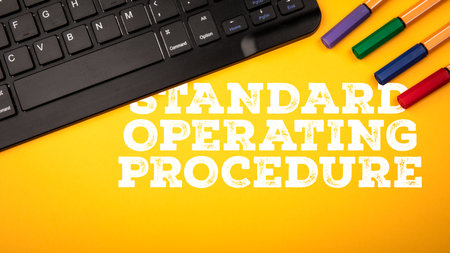Standard Operating Procedure Concept with Keyboard and Office Supplies on Yellow Backgroundの写真素材