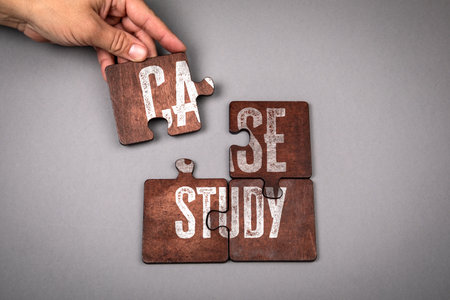 Hand Assembling Wooden Puzzle Pieces with Text Case Study Representing Research and Business...