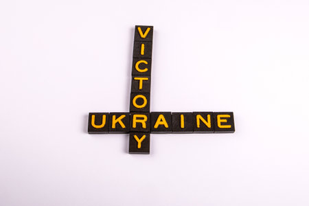 Word Victory and Ukraine Forming Cross Shape with Yellow Letters on White Backgroundの写真素材
