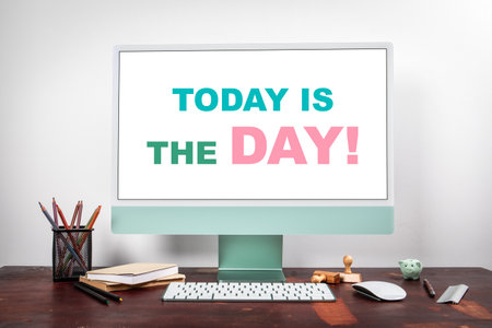 Inspirational Message Today Is The Day Displayed on Computer Screen in Modern Office Workspaceの写真素材