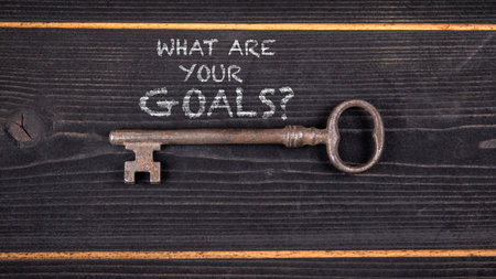 Motivational Question What Are Your Goals Written on wooden texture background with Vintage Key