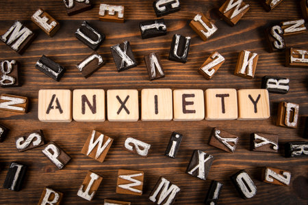 Word Anxiety Composed with Wooden Letter Blocks on Wooden Background Representing Stress and Mental Health Conceptの写真素材