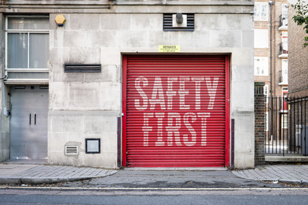 Red Industrial Garage Door With Large Safety First Warning Textの写真素材