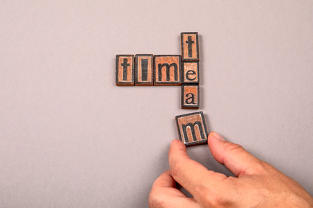 Time and Team Concept with Wooden Letter Blocks on Gray Backgroundの写真素材