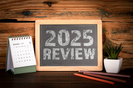 2025 Review. Desk Calendar and Chalkboard Messageの写真素材