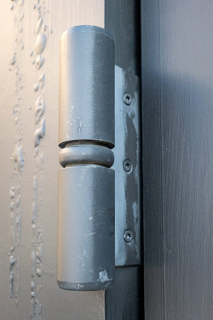 Metal Door Hinge Detail Mounted On Exterior Building Door Frame