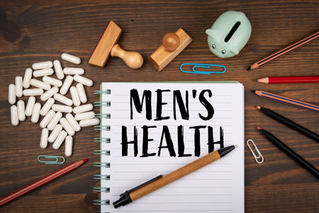 Notebook With MENS HEALTH Text Surrounded By Pillsの写真素材