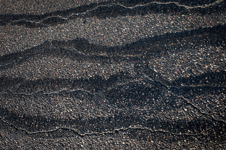 Cracked Asphalt Texture Background Showing Weathered Road Surface Detail