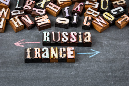 Russia France Direction Arrows with Wooden Letters on Chalkboard Background