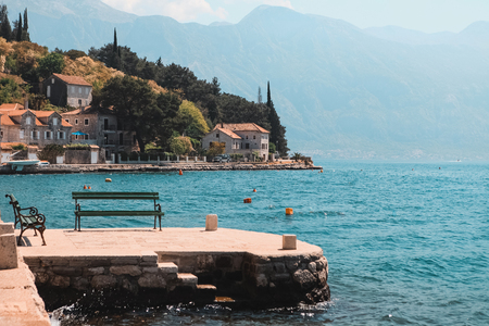 The bench with a magnificent view of Kotor bay and mountains in Perast, Montenegroの写真素材