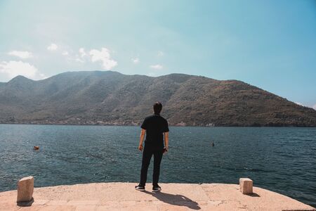 Perast, Montenegro April 24, 2018 a man traveling, relaxing, enjoying the view of the Adriatic Sea....