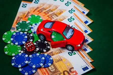Chips, money, euros on a poker green table with an audi typewriter in red.のeditorial素材
