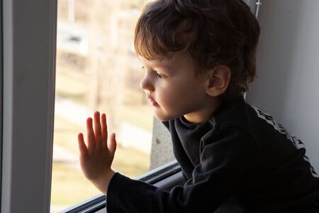 a bored single child during quarantine of the epidemic, Covid-19 looks out the window and dreams of...