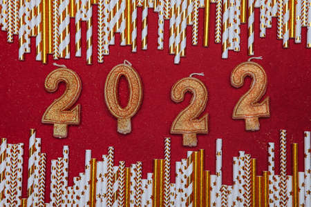 Candles number 2022. Christmas and New Years Eve. Postcard top view. Bright decoration red with gold
