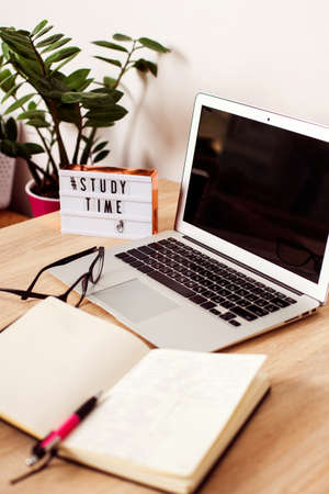 lightbox with the inscription time to study. In the background is a laptop, a notebook and a...