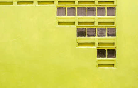 Concrete wall dark yellow color with blowhole for texture background
