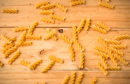 pasta on wooden rustic background in warm tone. Diet and food concept.