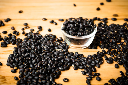 black bean seed on wooden rustic background in warm tone.の写真素材