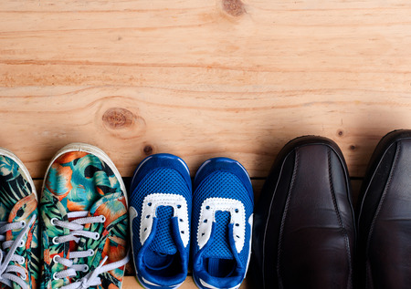 Shoes for the entire family on the wooden floor