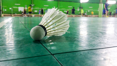 white Shuttlecock on badminton courts with players competingの写真素材