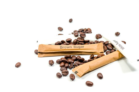 brown and white sugar with coffee bean seed on white backgroundの写真素材