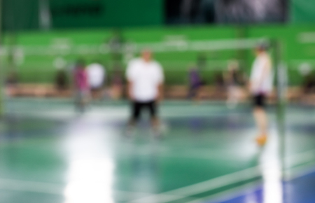 blurred of badminton court with players playing badmintonの写真素材