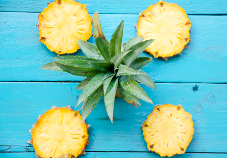 summer pineapple is slice for eat on blue wooden backgroundの写真素材