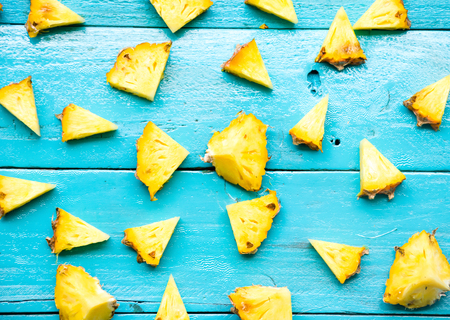 many pineapple is slice for eat on blue wooden backgroundの写真素材