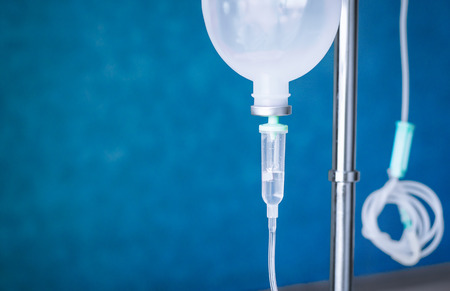 Close up saline IV drip for patient and Infusion pump in hospitalの写真素材